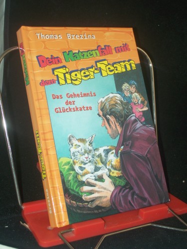Artikelbild des Artikels “Dein Katzenfall mit dem Tiger-Team : das Geheimnis der Glückskatze ; Rate-Krimi-Serie / von Thomas Brezina. Ill. von Rolf Bunse “